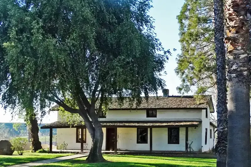 Single-story homes on a hillside street with mountains behind in Yucaipa